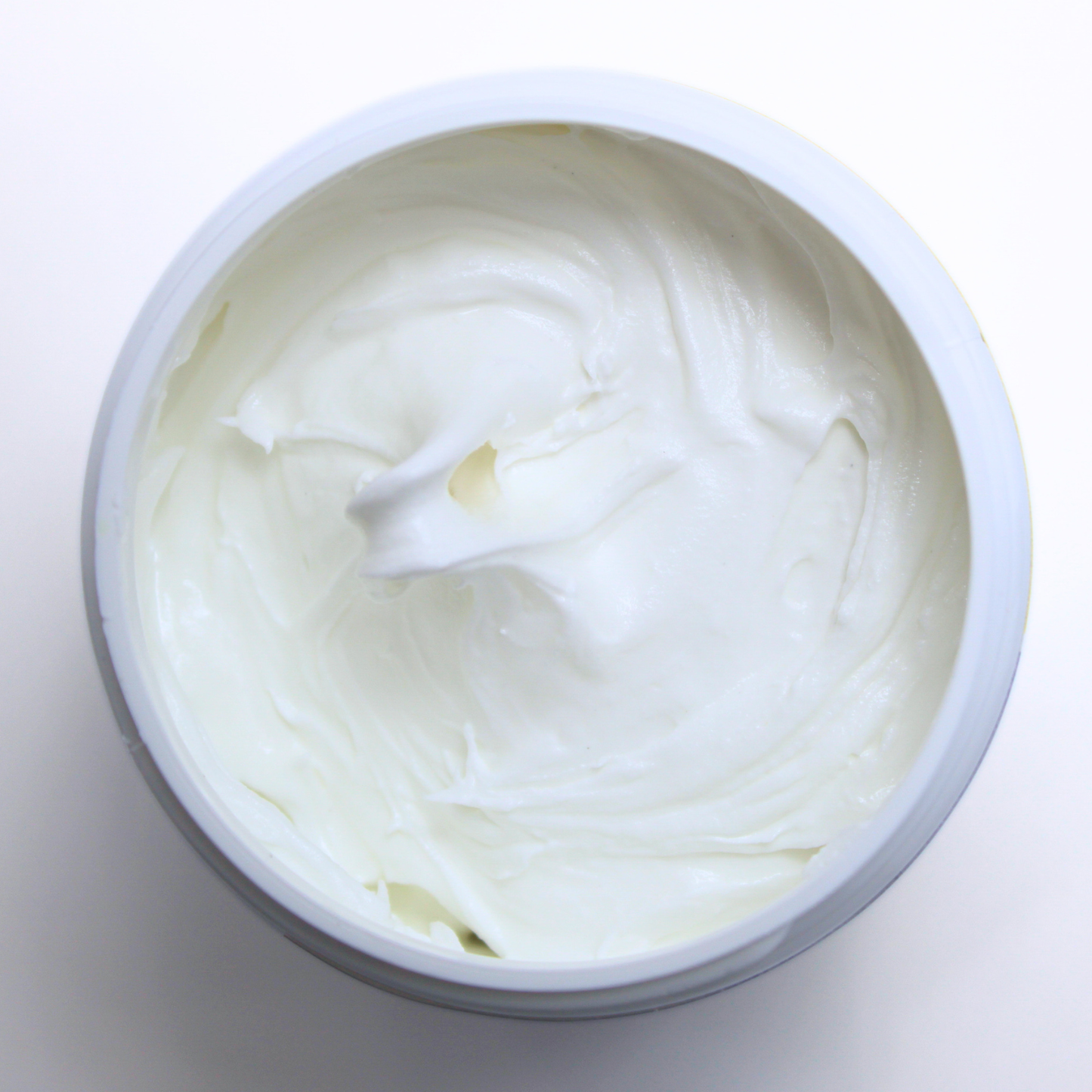 The Frost-It! Decorative Craft Frosting Jar sits open, revealing the adhesive’s smooth, white, frosting-like texture.