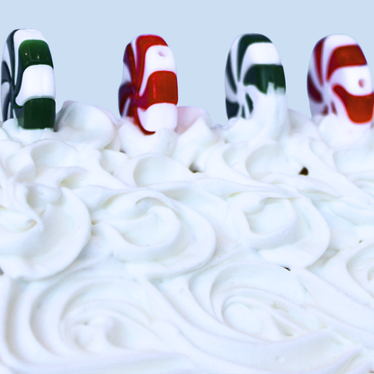 Close-up view of the swirled texture, applied to the roof of a cardboard gingerbread house, with peppermint charms securely adhered using Frost-It!