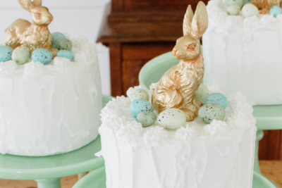 Faux Easter cakes adorned with a golden bunny and speckled robin eggs.